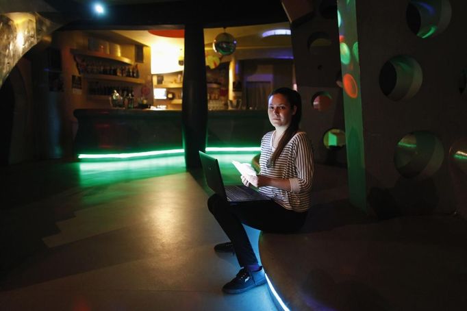 Daria Vitasovic, a 27 year-old bar manager, poses for a picture as she works on her laptop in a night bar in Zagreb, May 8, 2012. Vitasovic studied for seven years at Society of Jesus University where she received a degree in philosophy and religious sciences. She hoped to find a job in teaching or study for a PhD in philosophy but has been working as a bar manager for the past four years.