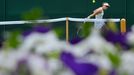 Samantha Stosur of Australia hits a return to Olga Puchkova of Russia in their women's singles tennis match at the Wimbledon Tennis Championships, in London June 27, 2013