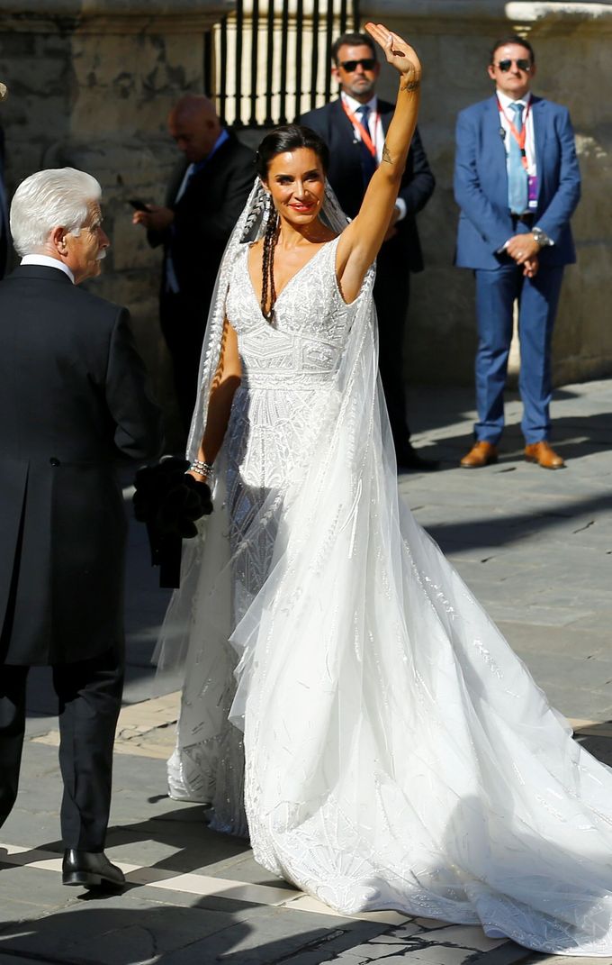 Real Madrid captain Sergio Ramos's fiancee Pilar Rubio waves next to her father Manuel Rubio at her wedding at the cathedral in Seville, Spain June 15, 2019. REUTERS/Marc