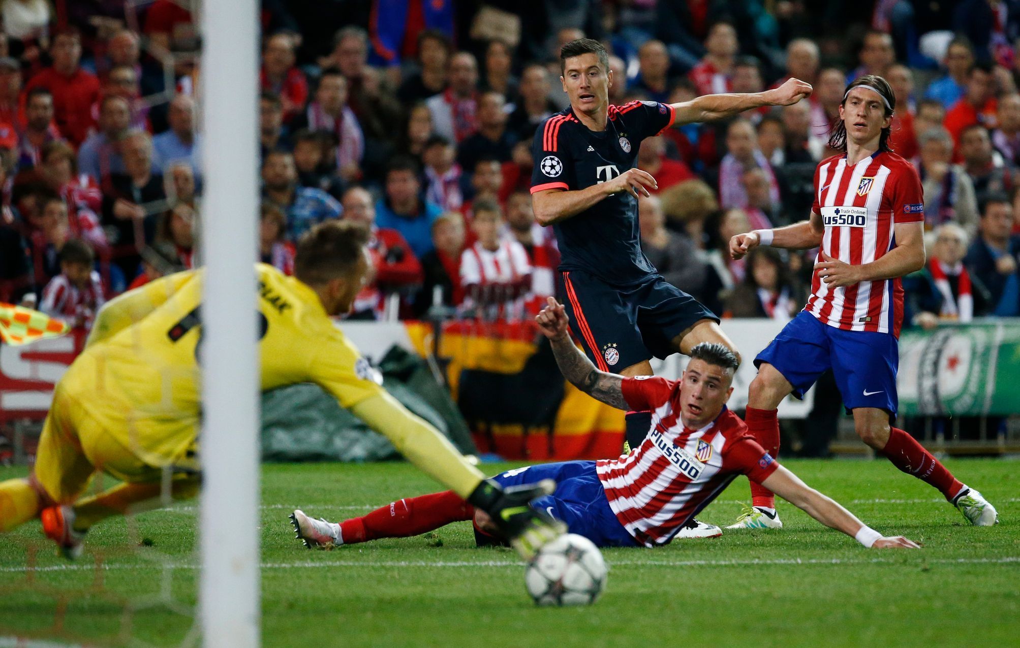 Atletico Madrid's Jan Oblak saves from Bayern Munich's Robert Lewandowski