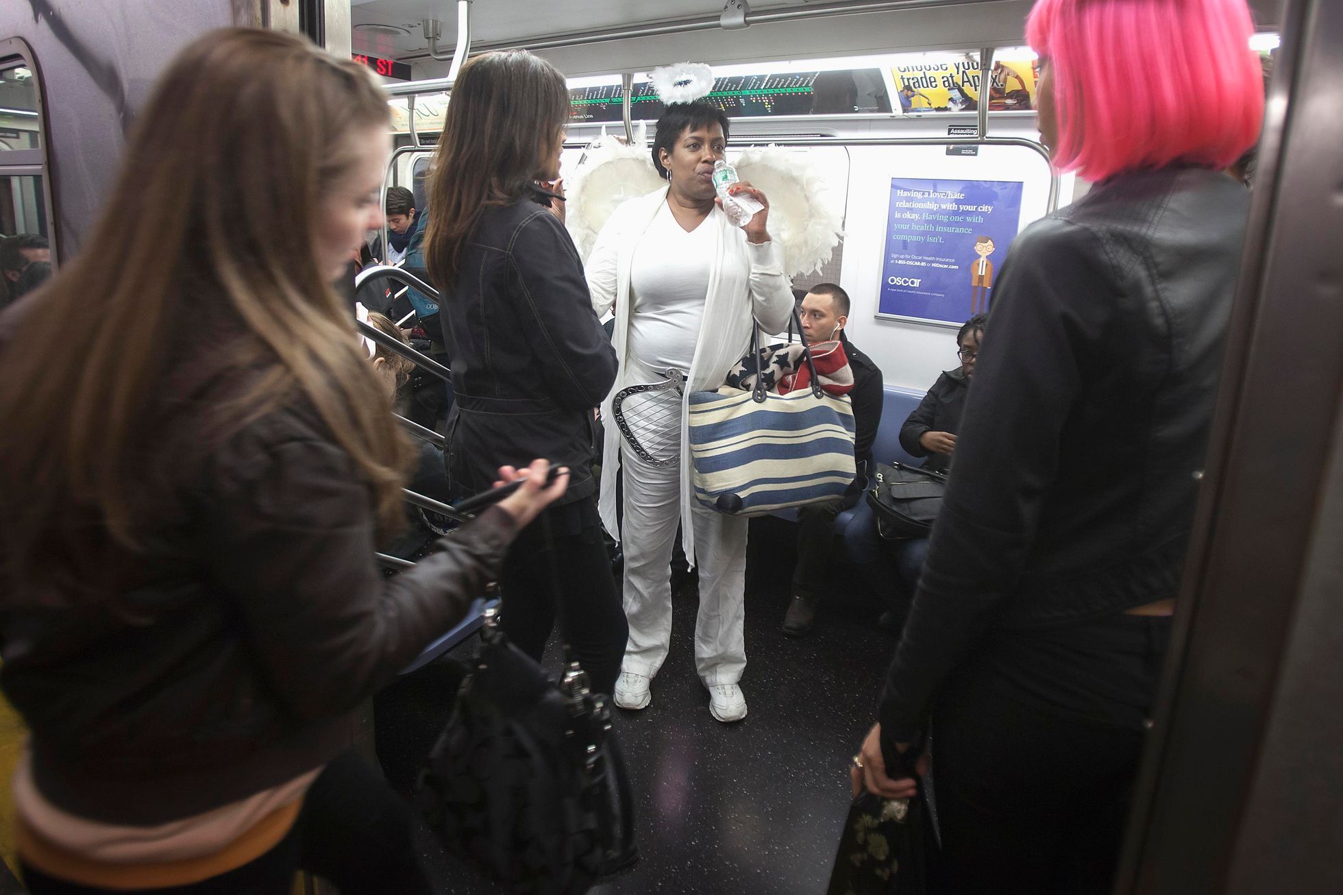 A participant in the Village Halloween Parade rides the subway dressed as an angel after the parade in the Manhattan borough of New York