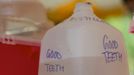 A dentist drops extracted teeth in a gallon jug of distilled water at the Remote Area Medical (RAM) clinic in Wise, Virginia July 20, 2012. RAM clinics bring free medical, dental and vision care to uninsured and under-insured people across the country and abroad. The Wise clinic was the 647th RAM expedition since 1985 and drew 1700 patients from 14 states, organizers said. Picture taken July 20, 2012. REUTERS/Mark Makela (UNITED STATES - Tags: HEALTH SOCIETY) Published: Čec. 24, 2012, 3:12 odp.