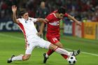 Arda Turana running with the ball as Zdeněk Grygera (2) is unsuccessfully trying to stop him.