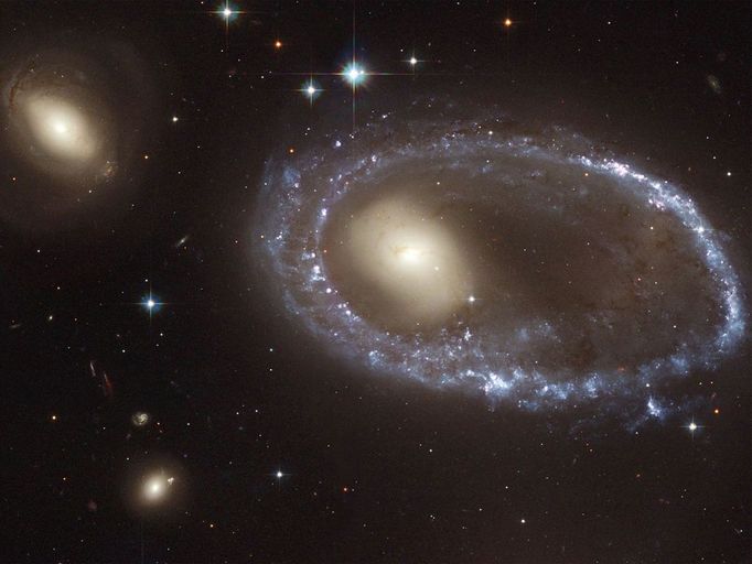 The Lure of the Rings Resembling a diamond-encrusted bracelet, a ring of brilliant blue star clusters wraps around the yellowish nucleus of what was once a normal spiral galaxy in this image from NASA's Hubble Space Telescope (HST). This image is being released to commemorate the 14th anniversary of Hubble's launch on April 24, 1990 and its deployment from the space shuttle Discovery on April 25, 1990. The galaxy, cataloged as AM 0644-741, is a member of the class of so-called "ring galaxies." It lies 300 million light-years away in the direction of the southern constellation Dorado. Image Credit: NASA/ESA/Hubble Heritage Team (AURA/STScI)