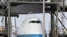 Space center workers watch as space shuttle Discovery is approached by a converted NASA 747 aircraft which is being towed into the Mate Demate facility at Kennedy Space Center in Cape Canaveral