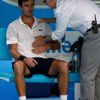 Doctor checks on Roger-Vasselin of France during a medical timeout in play in his men's singles match against Anderson of South Africa at Australian Open 2014 tennis tournament in Melbourne