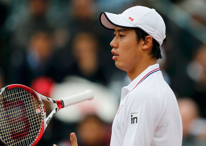 Kei Nishikori of Japan reacts during his men's singles match against Martin Klizan of Slovakia at the French Open tennis tournament at the Roland Garros stadium in Paris