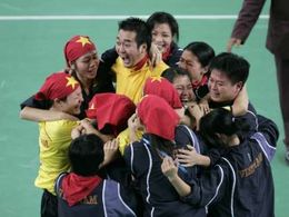 Hráčky Vietnamu a jejich trenér Ha Tung Lap (uprostřed) se radují z vítězství v sepaktakrawu na Asijských hrách v Dauhá.