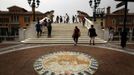 A Venetian Lion emblem adorns the footpath as pedestrians walk across a bridge over a canal that flows through the center of the Florentia Village in the district of Wuqing, located on the outskirts of the city of Tianjin June 13, 2012. The shopping center, which covers an area of some 200,000 square meters, was constructed on a former corn field at an estimated cost of US$220 million and copies old Italian-style architecture with Florentine arcades, a grand canal, bridges, and a building that resembles a Roman Coliseum. REUTERS/David Gray (CHINA - Tags: SOCIETY BUSINESS) Published: Čer. 13, 2012, 5:11 odp.