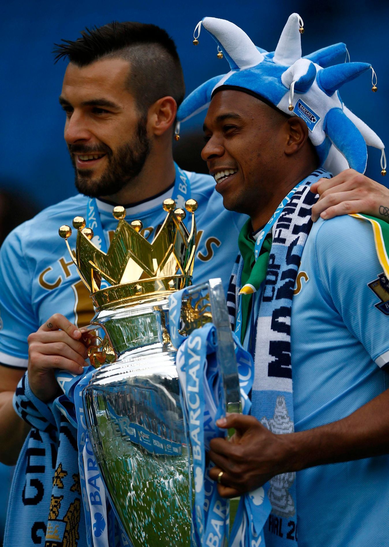 Manchester City's Alvaro Negredo and team mate Fernandinho celebrate after winning the English Premier League trophy