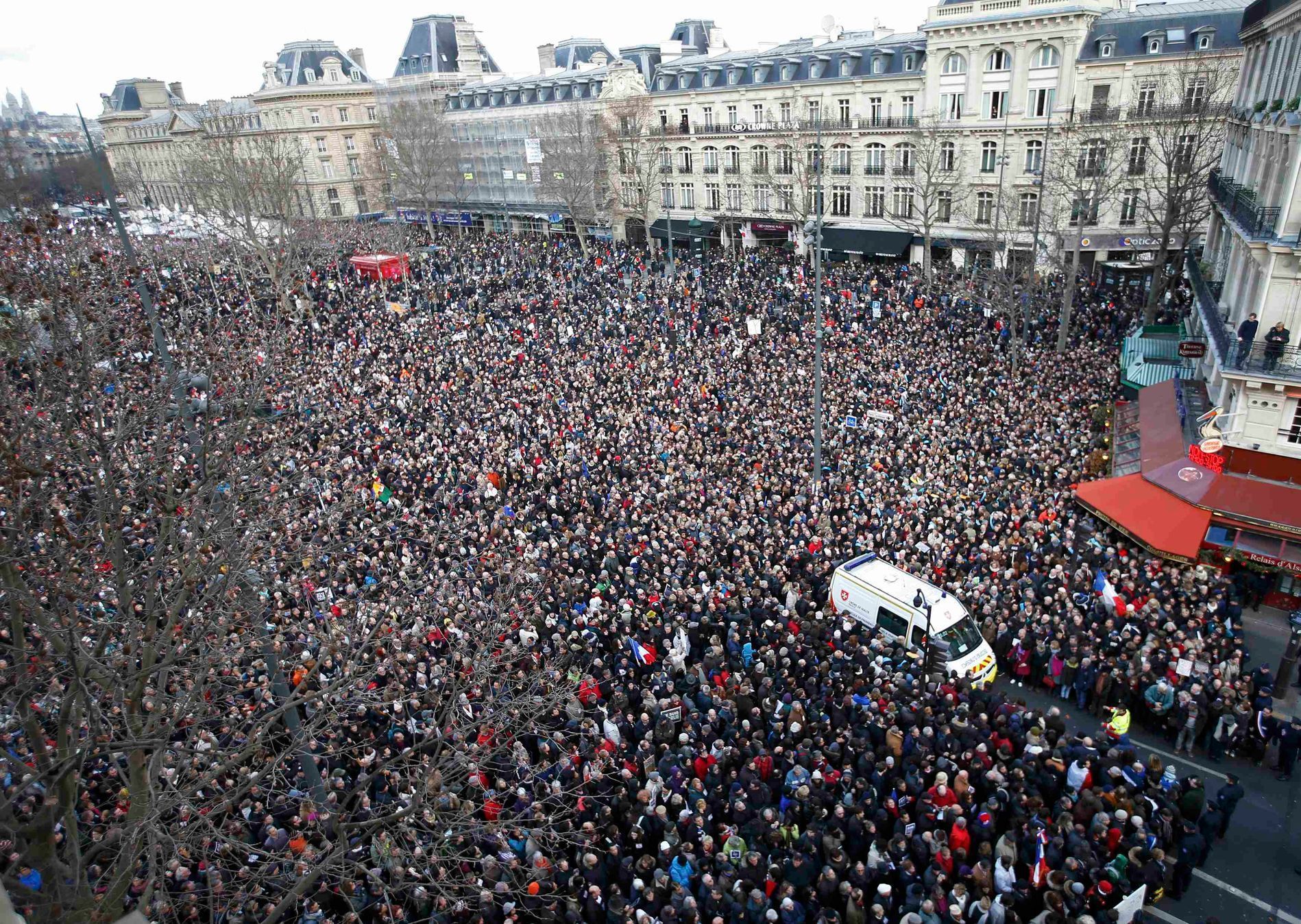 A general view shows an ambulance surrounded by hundreds of thousands of people gathering on the Place de la Republique to attend the solidarity march in the streets of Paris
