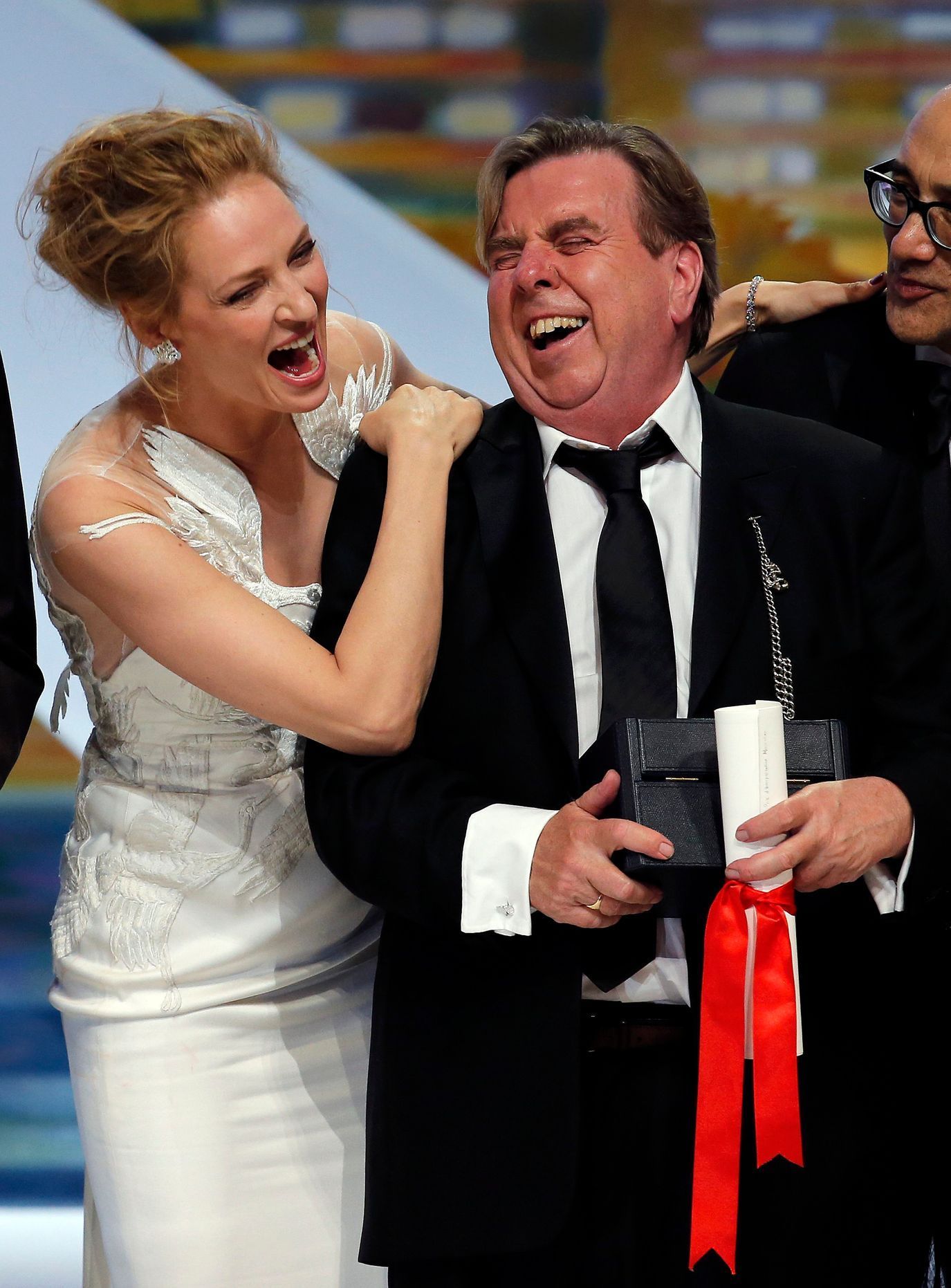 Actress Uma Thurman and actor Timothy Spall, Best Actor award winner for his role in the film &quot;Mr. Turner&quot;, pose on stage during the closing ceremony of the 67th Cannes Film Festival in Cann