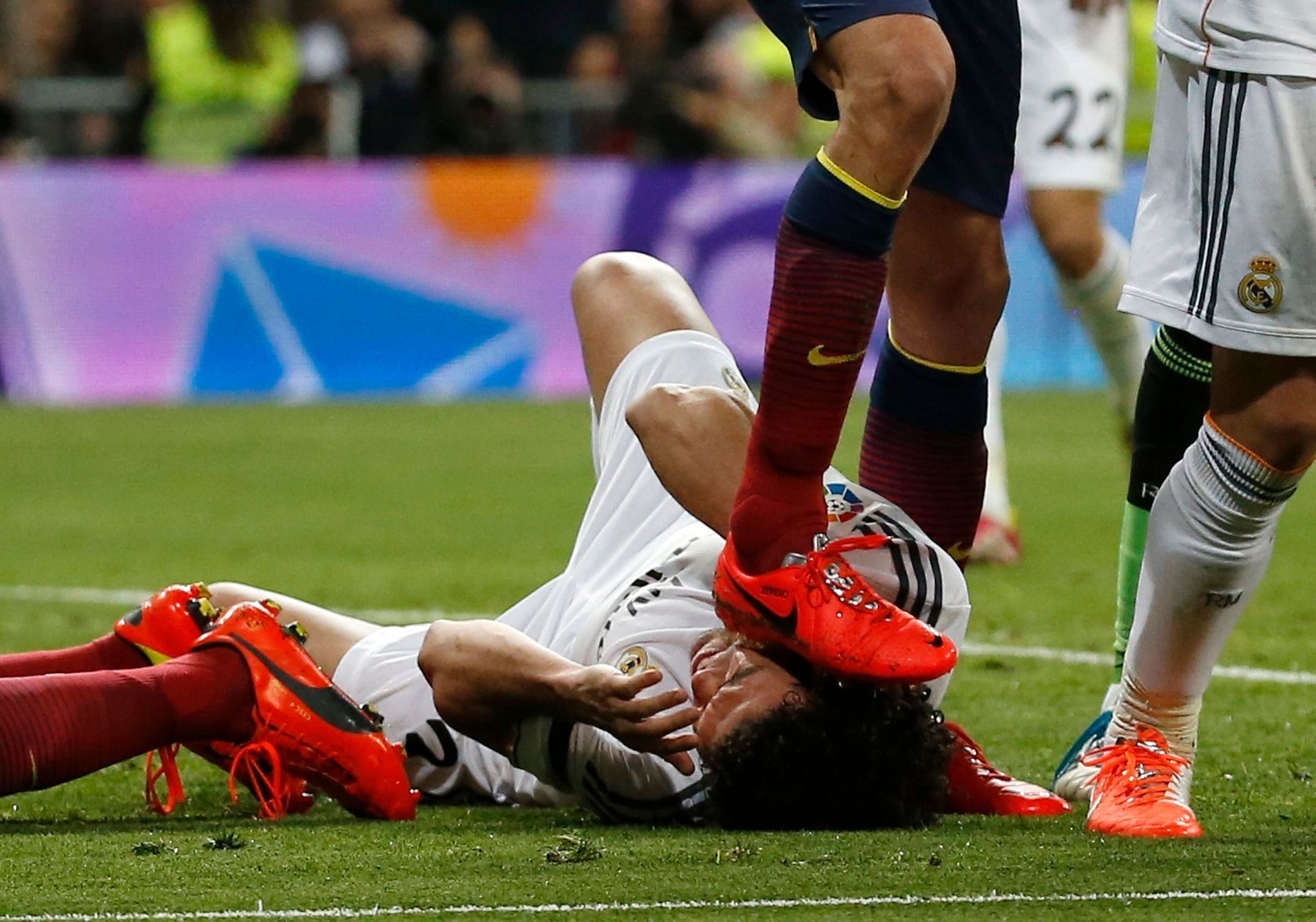 Barcelona's Busquets steps on the face of Real Madrid's Pepe during La Liga's second 'Clasico' soccer match in Madrid