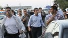 Bulgaria's President Rosen Plevneliev (C) walks near the site of an explosion at Bulgaria's Burgas airport July 18, 2012. At least four people were killed and over 20 injured by an explosion on a bus carrying Israeli tourists outside the airport of the Black Sea city of Burgas on Wednesday. The mayor of the city, on Bulgaria's Black Sea coast, said the bus was carrying Israeli tourists, but the police could not immediately confirm the nationality of the tourists. Police said several other buses at the site had been damaged. REUTERS/Nikolay Doncev (BULGARIA - Tags: DISASTER TRANSPORT POLITICS)