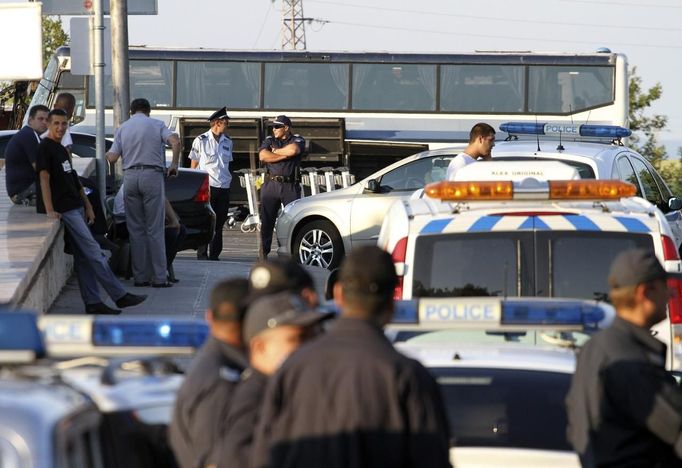 Police officers stand outside Bulgaria's Burgas airport July 18, 2012. Three people were killed and over 20 injured by an explosion on a bus carrying Israeli tourists outside the airport of the Black Sea city of Burgas on Wednesday. The mayor of the city, on Bulgaria's Black Sea coast, said the bus was carrying Israeli tourists, but the police could not immediately confirm the nationality of the tourists. Police said several other buses at the site had been damaged. REUTERS/Stringer (BULGARIA - Tags: DISASTER)