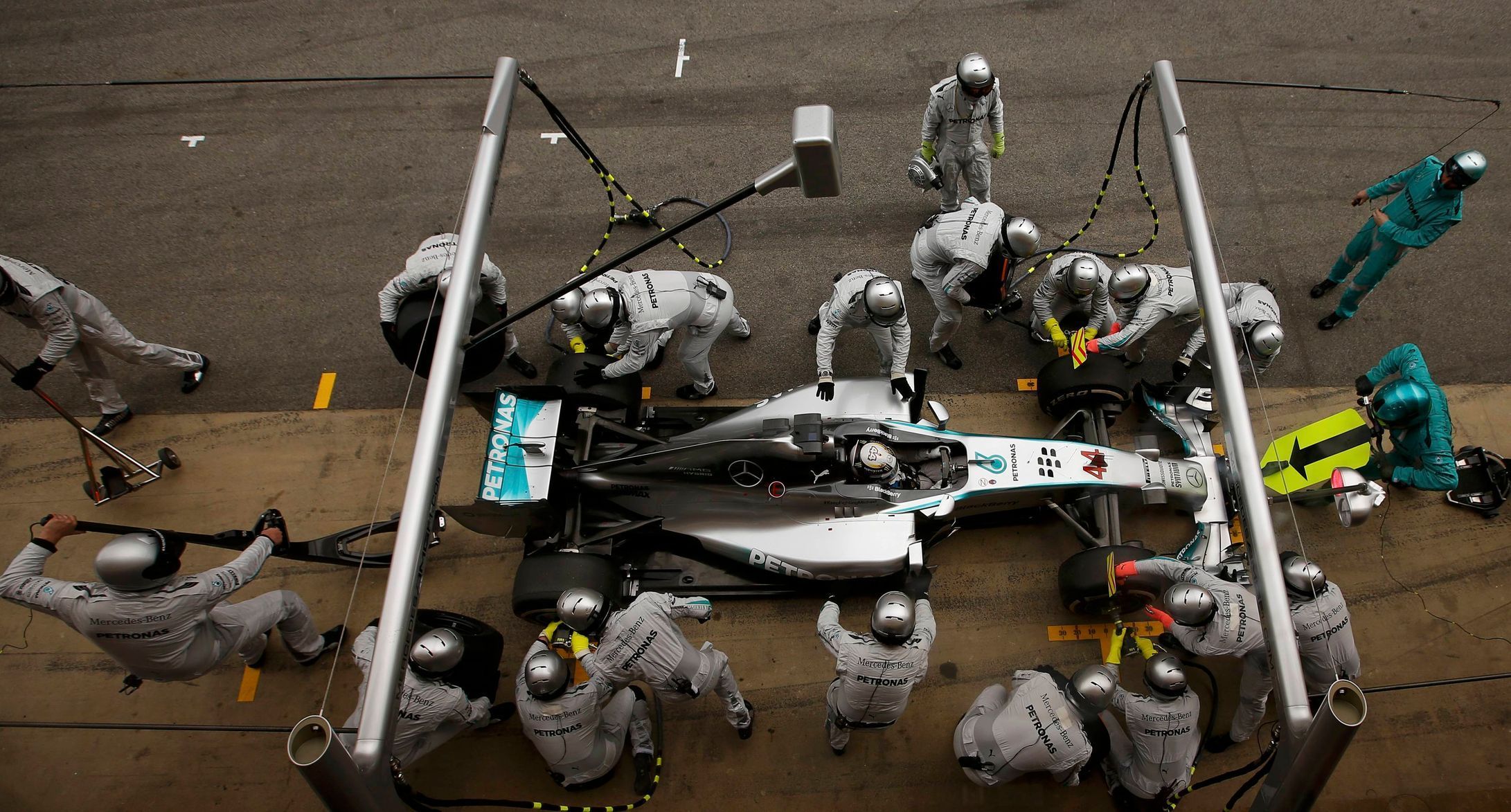 Crew members of Mercedes Formula One driver Hamilton of Britain service the car at pit stop during the Spanish F1 Grand Prix at the Barcelona-Catalunya Circuit in Montmelo