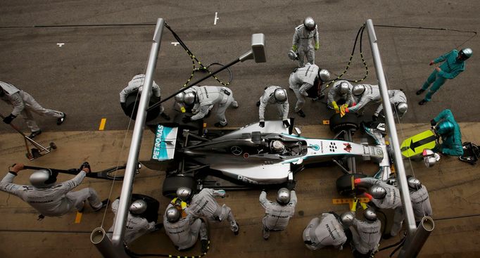 Crew members of Mercedes Formula One driver Lewis Hamilton of Britain service the car at pit stop during the Spanish F1 Grand Prix at the Barcelona-Catalunya Circuit in M