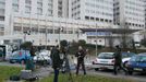 Journalists work in front of the entrance of the emergency services at the CHU Nord hospital in Grenoble, French Alps, where retired seven-times Formula One world champio