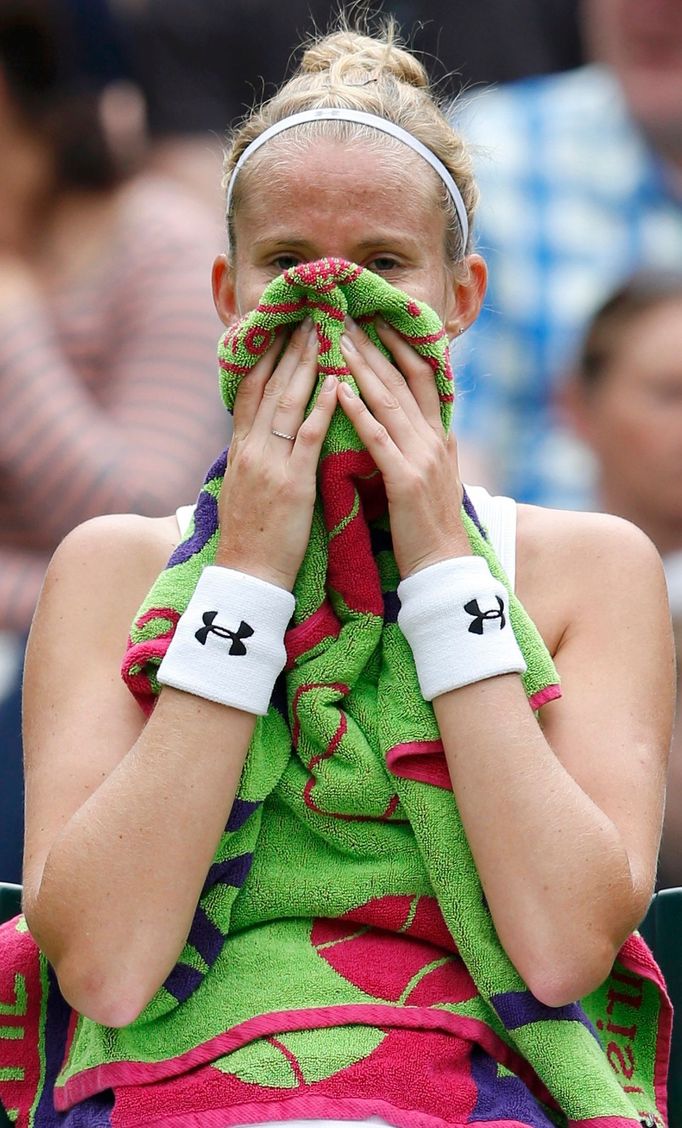 Mathilde Johansson of France sits in her seat after losing the first set during her women's singles tennis match against Agnieszka Radwanska of Poland at the Wimbledon Te