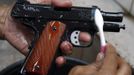 A gun factory worker uses a toothbrush to clean a newly produced caliber 45 pistol at Shooters Arms, a gun manufacturing company exporting different kinds of weapons to other countries, in Cebu city in central Philippines July 7, 2012. In the Philippines, they vote with their trigger fingers. Elections mean big business for illegal gunsmiths, who are looking forward to 2013 mid-term polls. With election-related violence commonplace, the Philippines imposes a ban on the carrying of guns for six months, from campaigning to the proclamation of winners. Picture taken July 7, 2012. To match Feature PHILIPPINES-GUNS/ REUTERS/Erik De Castro (PHILIPPINES - Tags: SOCIETY POLITICS BUSINESS CRIME LAW) Published: Čec. 29, 2012, 2:07 dop.