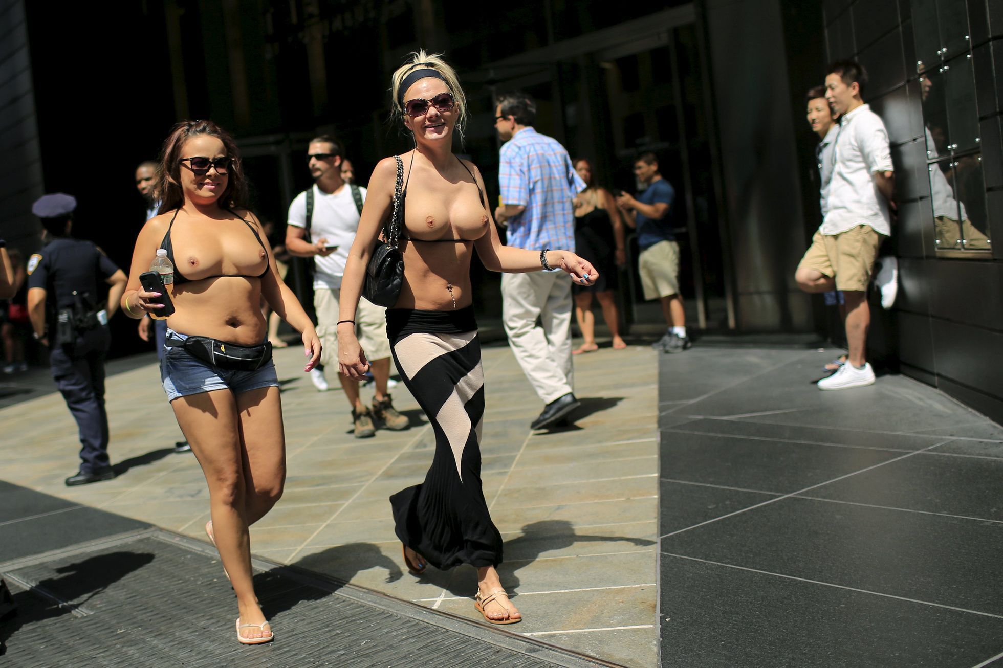 Women arrive to take part in a topless march in New York