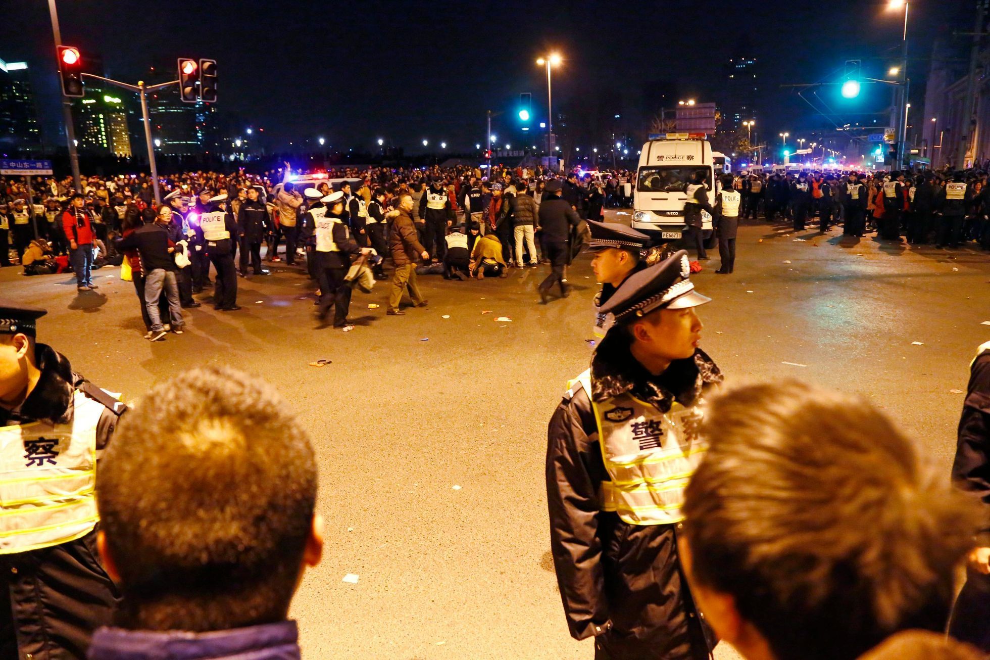 Police control the site of a stampede that occurred during a New Year's celebration on the Bund, in central Shanghai