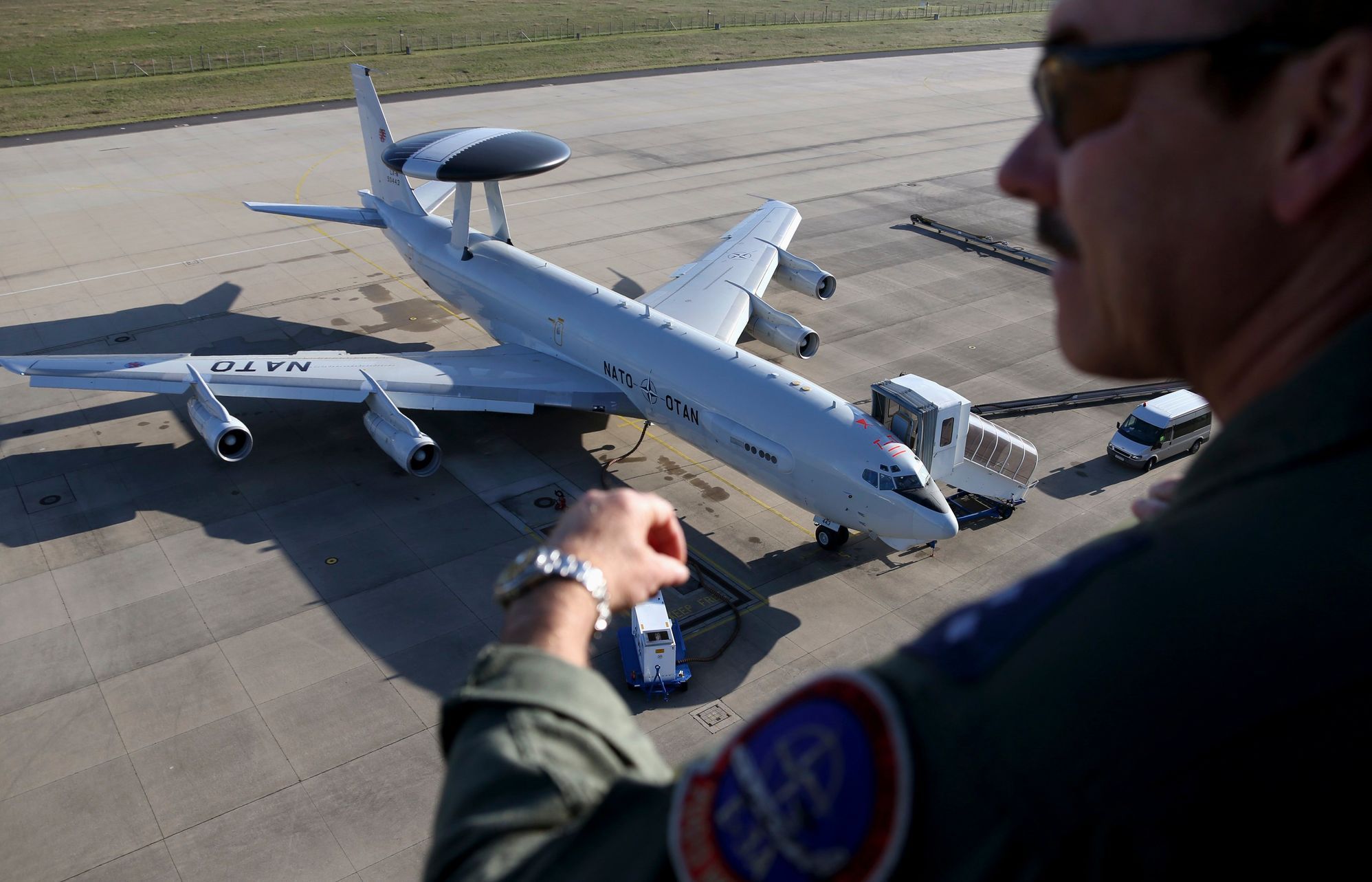NATO officer watches a AWACS aircraft at AWACS air base in Geilenkirchen near the German-Dutch border