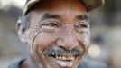 An miner named Ramon flashes a gold letter 'R' on his tooth as he smiles after working in a mine in the southern state of Bolivar November 15, 2012. In the triangle that connects Venezuela, Brazil and Guyana a huge number of illegal gold and diamonds prospectors or garimpeiros dream of changing their lives overnight by finding a huge bonanza. Picture taken November 15, 2012. REUTERS/Jorge Silva (VENEZUELA - Tags: BUSINESS EMPLOYMENT SOCIETY) ATTENTION EDITORS: PICTURE 10 OF 20 FOR PACKAGE 'DIAMONDS IN THE JUNGLE'. TO FIND ALL IMAGES SEARCH 'DIAMONDS PROSPECTORS' Published: Pro. 3, 2012, 10:01 dop.