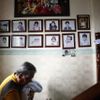 South Korean pastor Lee Jong-rak carries a baby, abandoned a day earlier at a "baby box" at his Joosarang church, to hand it over to ward officials as portraits of other abandoned children raised and adopted by him are seen on a wall of the church in Seoul September 20, 2012. Lee, who runs the "baby box" where mothers can leave unwanted infants, has seen a sharp increase in the number of newborns being left there because, the pastor says, of a new law aimed protecting the rights of children. South Korea is trying to shed a reputation of being a source of babies for adoption by people abroad. It is encouraging domestic adoption and tightening up the process of a child's transfer from birth mother to adoptive parents. Picture taken September 20, 2012. REUTERS/Kim Hong-Ji (SOUTH KOREA - Tags: SOCIETY) Published: Říj. 7, 2012, 6:59 dop.