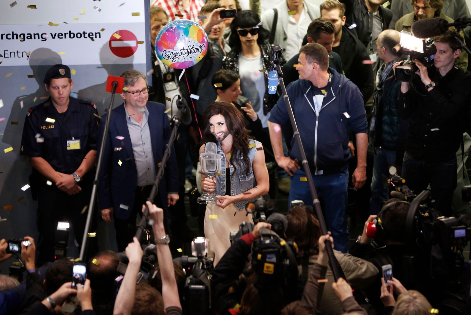 Austria's Conchita Wurst arrives with her trophy at Vienna's airport