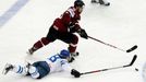 Latvia's Kaspars Daugavins (top) and Latvia's Zemgus Girgensons chase the puck during the second period of their men's ice hockey World Championship group B game at Minsk