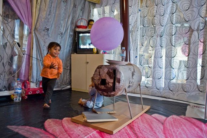 34 Titulek: Albanian gypsies face poverty in Greece Popis: October 22, 2011, Athens, Greece: October 22, 2011 - Athens, Greece: Gypsy girl plays with a balloon and her baby brother near the stove in the squatter to cook the food with. 800 Albanian gypsies live under extreme unhealthy conditions since 2000 in a township on an occupied, private property, only three km below Acropolis. Greek authorities are not able to transfer the gypsies to another legal land in order to gain access to clean water, sanitary and electricity- due to financial crisis. In October 2013, an unidentified girl, called "Maria," was found in a Greek gypsy camp and could be related to missing child cases. Over 8,000 calls about the girl from all over the world including the U.S. and Canada have been received inquiring about the child. The blond girl, approximately age 4, was found in a Roma gypsy settlement in central Greece. DNA tests proved that she was not related to the 39-year-old man and 40-year-old woman who claimed to be her parents.