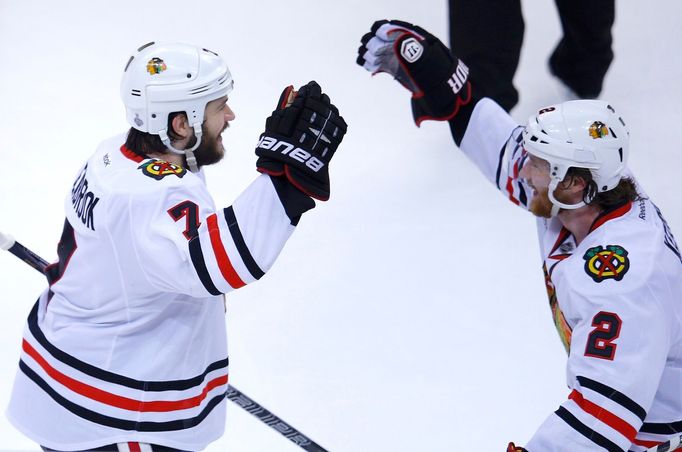 Chicago Blackhawks' Brent Seabrook (L) celebrates his game-winning goal against the Boston Bruins with teammate Duncan Keith during overtime in Game 4 of their NHL Stanle