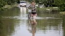 A local resident pulls his bicycle along a flooded street in the town of Krymsk in Krasnodar region, southern Russia, July 8, 2012. Russian President Vladimir Putin ordered investigators to find out if enough was done to prevent 144 people being killed in floods in southern Russia after flying to the region to deal with the first big disaster of his new presidency. REUTERS/Eduard Korniyenko (RUSSIA - Tags: DISASTER ENVIRONMENT POLITICS) Published: Čec. 8, 2012, 7:09 dop.