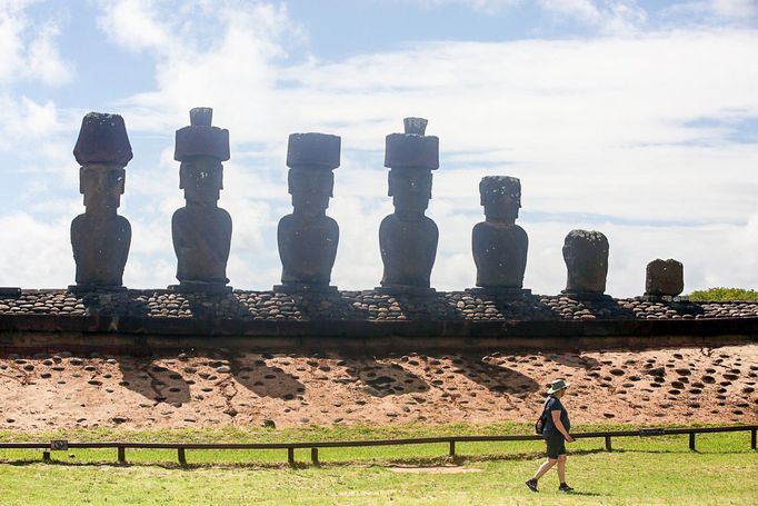 Osoba prochází před plošinou Ahu Nau Nau se sedmi sochami moai na pobřeží Velikonočního ostrova, Chile, 2. dubna 2024.