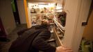 Anna-Rae Douglass, 23, a pracitsing 'freegan', looks through her fridge of scavenged food at her house in Vancouver, British Columbia April 10, 2012. A 'Freegan' is someone who gathers edible food from the garbage bins of grocery stores or food stands that would otherwise have been thrown away. Freegans aim to spend little or no money purchasing food and other goods, not through financial need but to try to address issues of over-consumption and excess. Picture taken April 10, 2012. REUTERS/Ben Nelms (CANADA - Tags: SOCIETY) ATTENTION EDITORS PICTURE 08 OF 21 FOR PACKAGE 'DUMPSTER DIVING FOR FOOD' Published: Kvě. 15, 2012, 11:58 dop