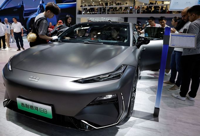 A staff member cleans the Geely Galaxy E8 electric vehicle at the Beijing International Automotive Exhibition, or Auto China 2024, in Beijing, China, April 25, 2024. REUT