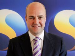 Švédský premiér Fredrik Reinfeldt a logo dalšího předsednictví.