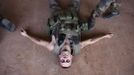 A French soldier lies on the ground during training for emergency first aid at the Malian army air base in Bamako January 14, 2013. France, which has poured hundreds of troops into the capital Bamako in recent days, carried out more air raids on Monday in the vast desert area seized last year by an Islamist alliance grouping al Qaeda's north African wing AQIM alongside Mali's home-grown MUJWA and Ansar Dine militant groups. REUTERS/Joe Penney (MALI - Tags: POLITICS MILITARY) Published: Led. 14, 2013, 6:01 odp.