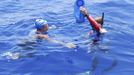 Endurance swimmer Diana Nyad is hydrated by a crew member in the Florida Straits between Cuba and the Florida Keys in this August 20, 2012 handout photo. After being delayed by a weather squall line late Sunday night and early Monday morning, her team reported that Nyad was back on course in her effort to be the first swimmer to transit the Florida Straits from Cuba to the Keys without a shark cage.REUTERS/Christi Barli/Diana Nyad/Florida Keys News Bureau/Handout. (UNITED STATES - Tags: PROFILE SPORT SOCIETY) NO SALES. NO ARCHIVES. FOR EDITORIAL USE ONLY. NOT FOR SALE FOR MARKETING OR ADVERTISING CAMPAIGNS. THIS IMAGE HAS BEEN SUPPLIED BY A THIRD PARTY. IT IS DISTRIBUTED, EXACTLY AS RECEIVED BY REUTERS, AS A SERVICE TO CLIENTS Published: Srp. 20, 2012, 10:15 odp.