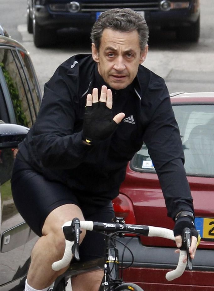 France's President and UMP candidate for the 2012 French presidential election Sarkozy cycles away from home of First Lady Bruni-Sarkozy in Cavaliere