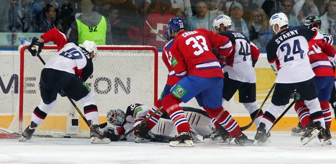 Hokejista Lva Praha Zdeno Chára střílí přes Michala Miklíka, Jaroslava Jánuse, Andreje Sekeru a Ivana Švarného v utkání KHL 2012/13 proti Slovanu Bratislava.