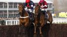 Barry Geraghty on Bobs Worth (L) jumps the last fence next to Davy Russell on First Lieutenant to go on and win the RSA Steeple Chase at the Cheltenham Festival horse racing meet in Gloucestershire, western England March 14, 2012.