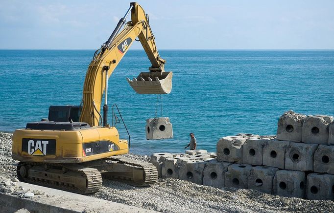 Olympic Park under construction in Sochi, Russia SOCHI, RUSSIA. MAY 20, 2013. An excavator placing shore defences on the seafront of Olympic Park. In 2014 Sochi is set to host 2014 Winter Olympic Games.