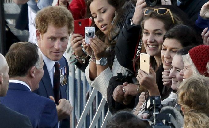 Britain's Prince Harry and New Zealand's Prime Minister John Key meet members of the public during his visit to the National War memorial in Wellington