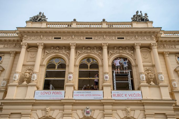 Pracovníci natírají okenní rámy na průčelí budovy Divadla F. X. Šaldy.