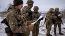 Ukrainian servicemen of the 93rd separate mechanized brigade sing during a Christmas Day service near the front line in the Donetsk region as Ukrainians celebrate their f