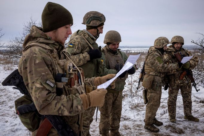 Ukrainian servicemen of the 93rd separate mechanized brigade sing during a Christmas Day service near the front line in the Donetsk region as Ukrainians celebrate their f