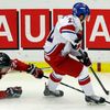 Canada's Dumba dives for the puck carried by Czech Republic's Simon during the second period of their IIHF World Junior Championship ice hockey game in Malmo