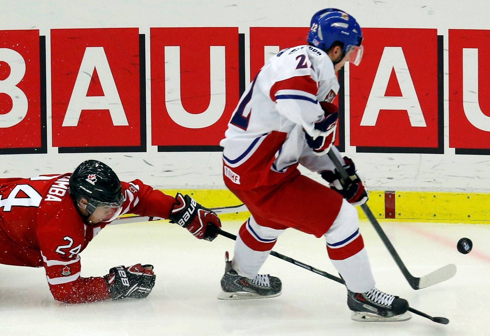 Canada's Dumba dives for the puck carried by Czech Republic's Simon during the second period of their IIHF World Junior Championship ice hockey game in Malmo